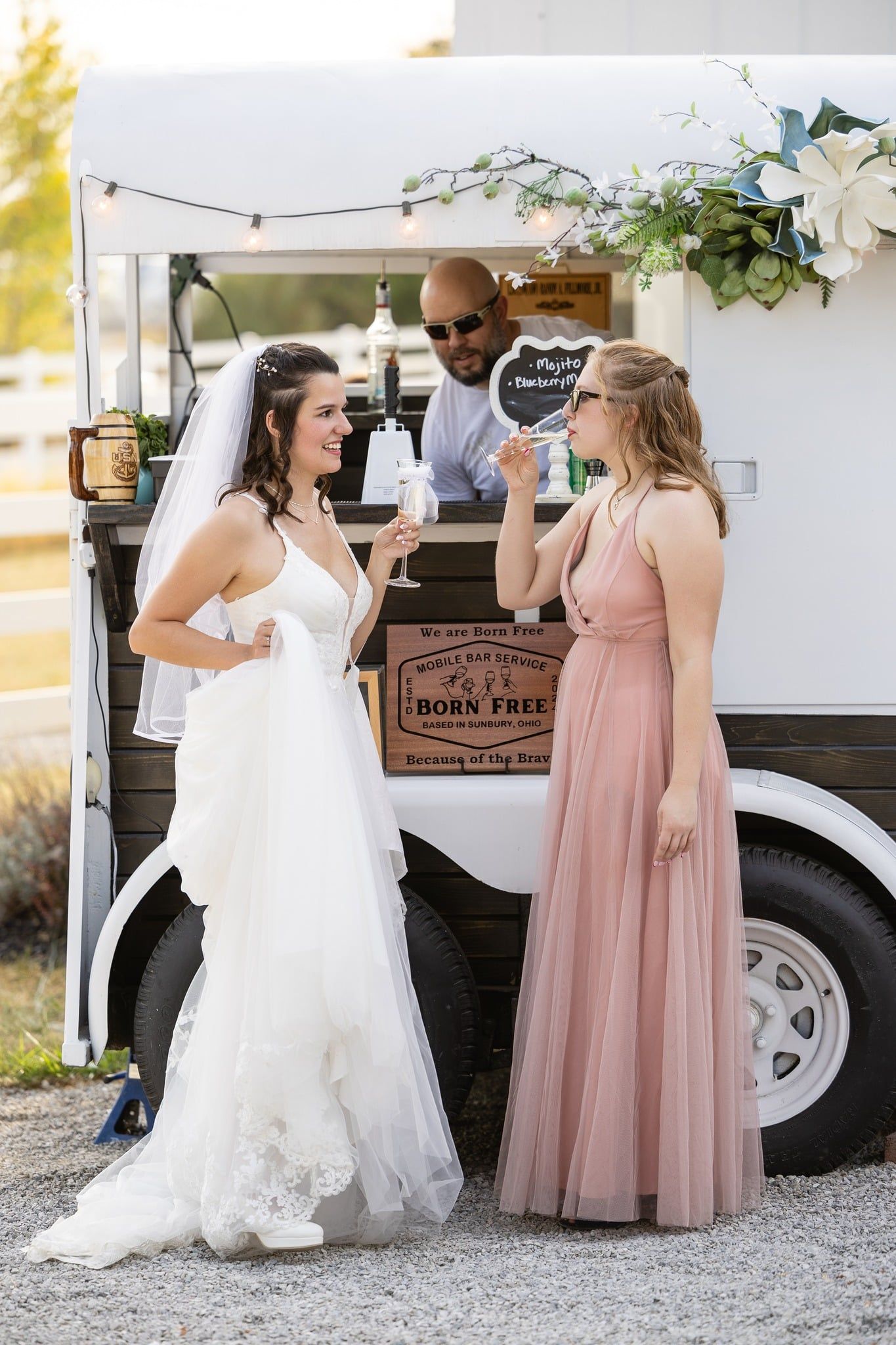 Founder Randy with bride and groom at an outdoor wedding venue